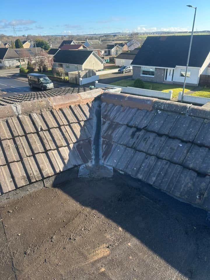 Finished lead valley dressed between two tiled slopes, with new ridge tiles at the top