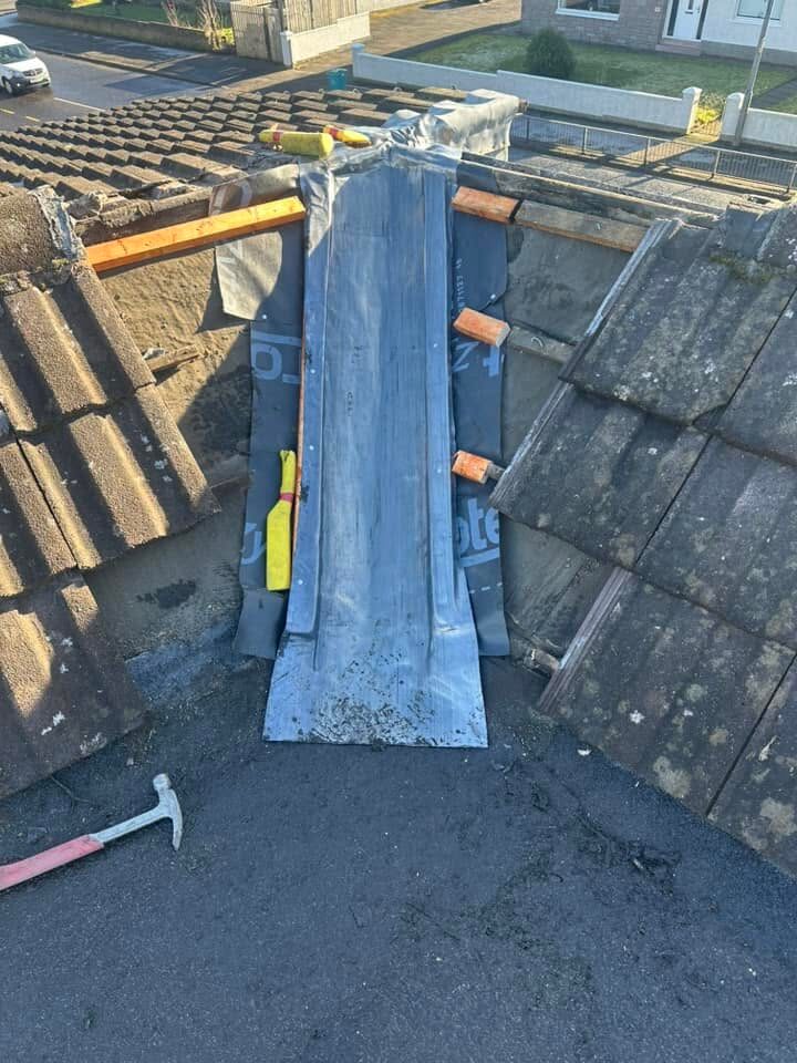 New lead laid in the valley with the tiled slopes still open either side