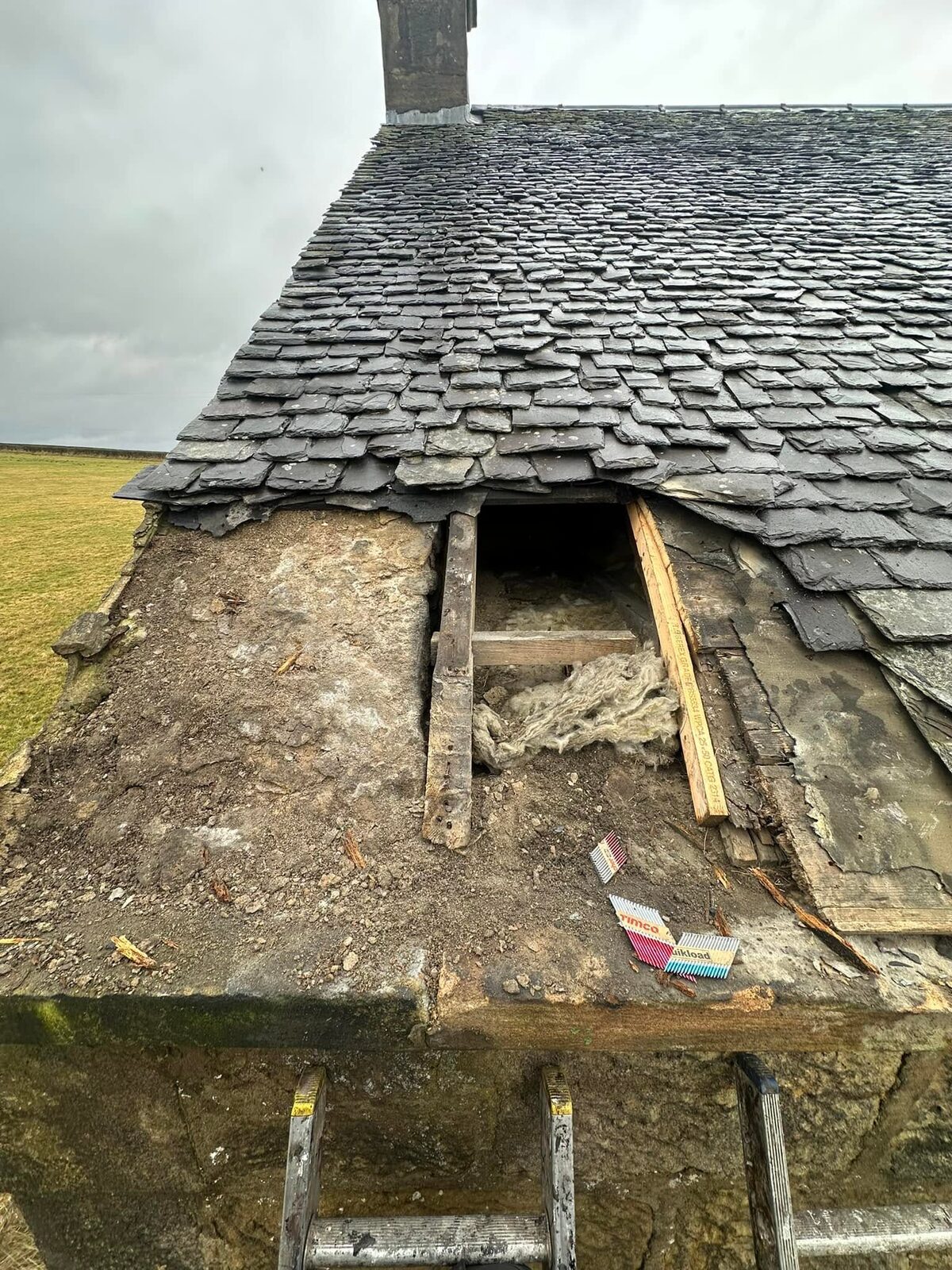 Eaves stripped back with the rotten boards removed and the rafters showing